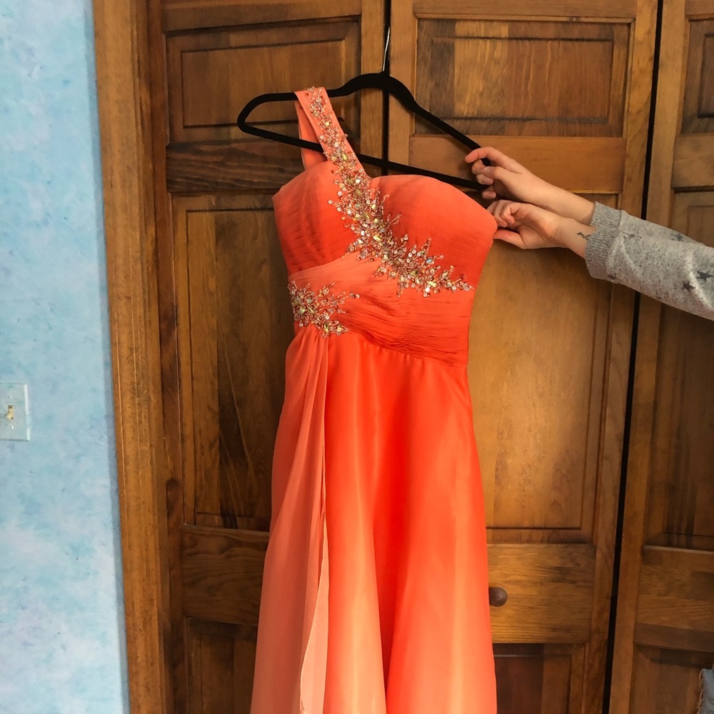 Elegant gown. Bodice has ruching, beading, crystals, one strap. Skirt overlay